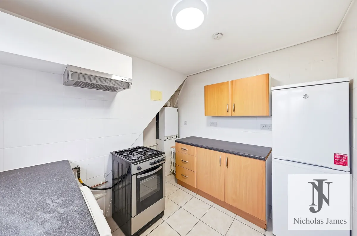 Kitchen with a gas cooker and fridge freezer